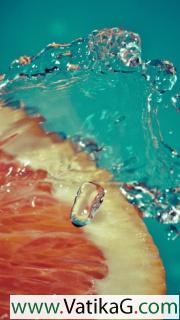 Orange slice in water drops